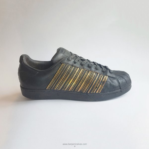 Bronze sculpture of Adidas Superstar sneaker with barcode